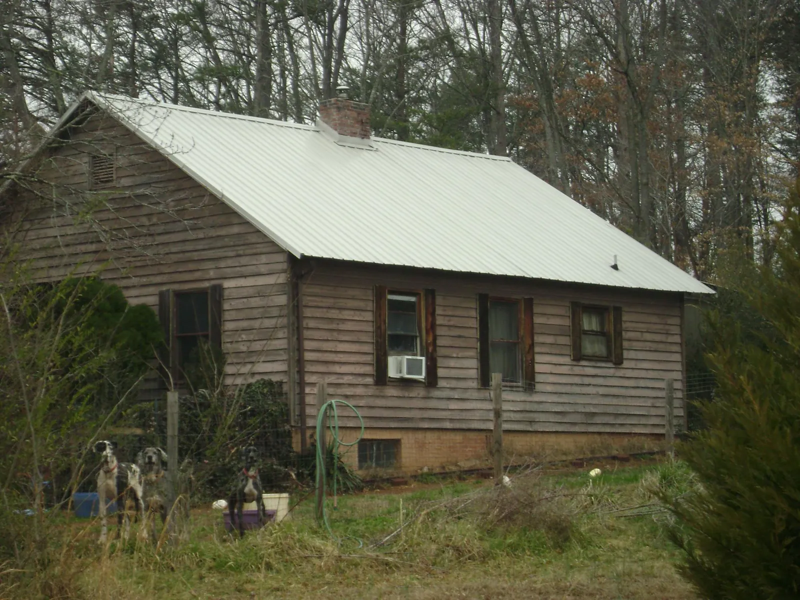 White metal roof on an old wood sided farmhouse, from a Metal Roof Installation job in Prague